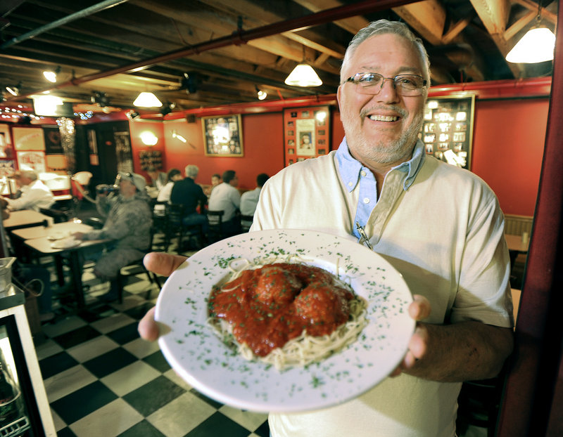 Anthony Barrasso, owner of Anthony's Italian Kitchen in Portland, holds a heaping plate of his fourth-generation homemade meatballs nestled on spaghetti and covered with Italian gravy.