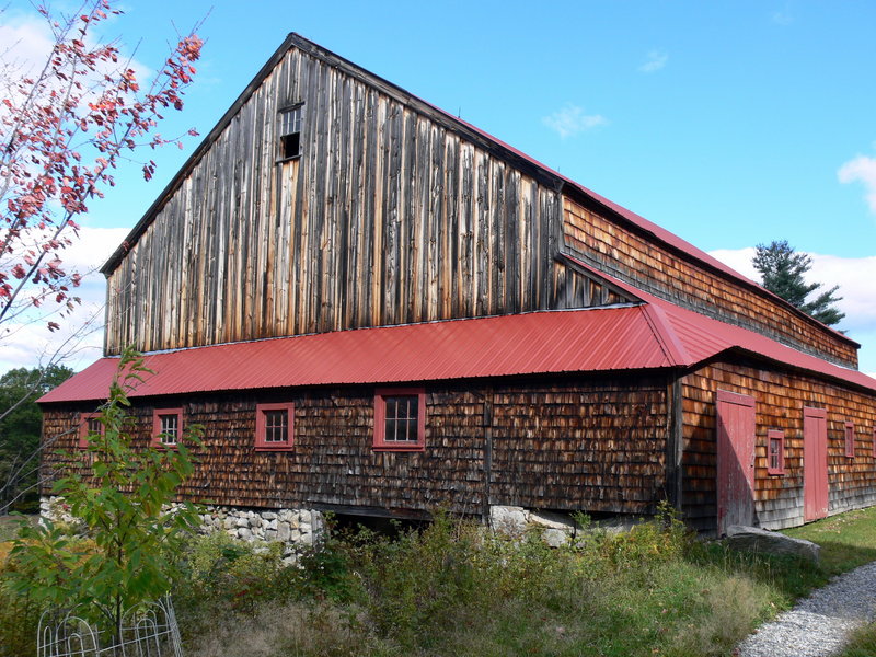 This Sebago barn was lengthened, nearly doubling its footprint, before receiving several lean-to-like additions.