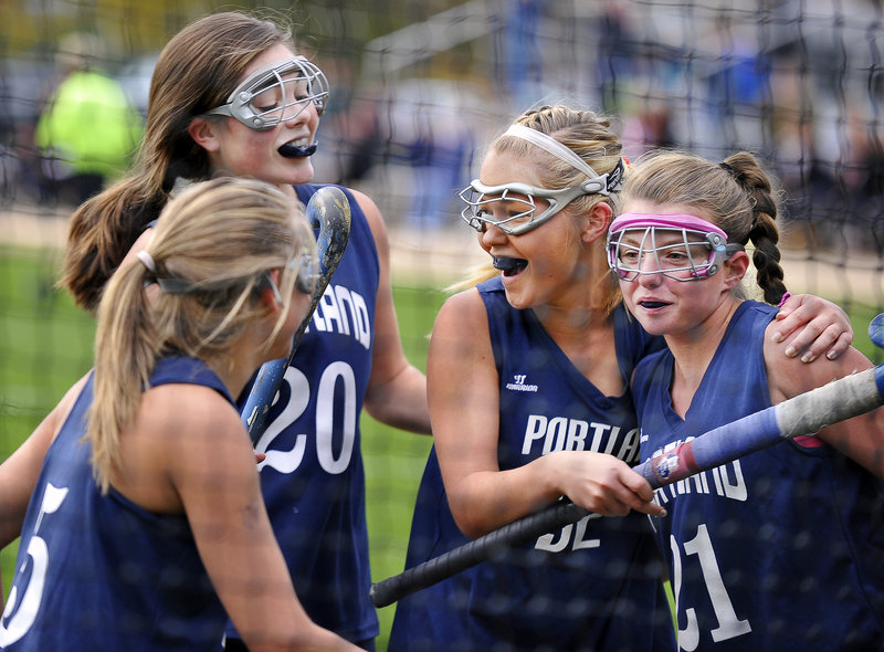 Carissa Porcaro, right, celebrates with her Portland High teammates Tuesday after scoring the first goal in a 3-1 victory against Sanford in a Western Class A field hockey quarterfinal. From left are Kristina Brown, Kylie Dalbec and Kaitlyn Rutherford.