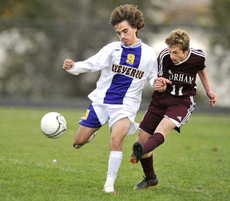 Gorham's #11, Mike Lubelczyk, gets off a shot while defended by Cheverus' #9, Alex Hoglund.
