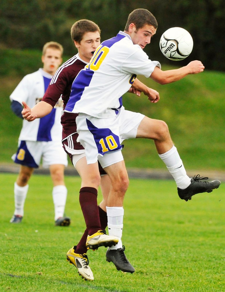 Gorham’s Kevin Lubelczyk, rear, challenges Cheverus’ Nick Melville as Melville heads the ball away Tuesdays. The Rams won, 6-3.