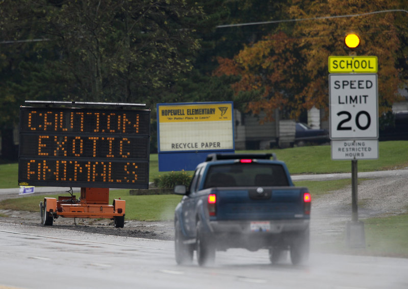 Traffic signs warn drivers to stay in their cars because exotic animals were on the loose near Zanesville, Ohio, on Wednesday. Wild bears and other animals from an exotic-animal farm were still roaming free in a rural area of eastern Ohio on Wednesday morning. A monkey was the only animal still at large Wednesday night.
