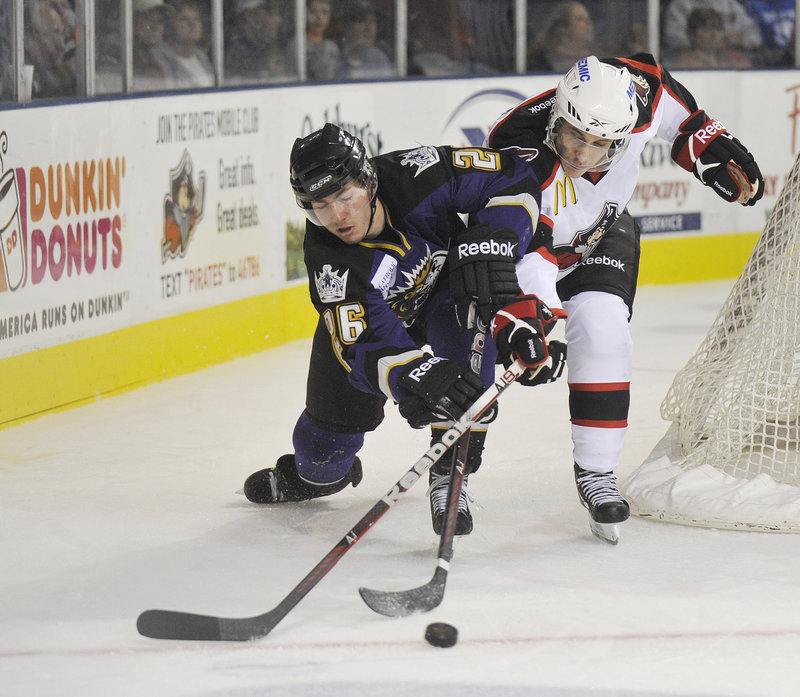 Brandon Kozun of the Manchester Monarchs, left, competes with Andy Miele of the Portland Pirates for the puck Wednesday night during the Pirates 5-3 victory.