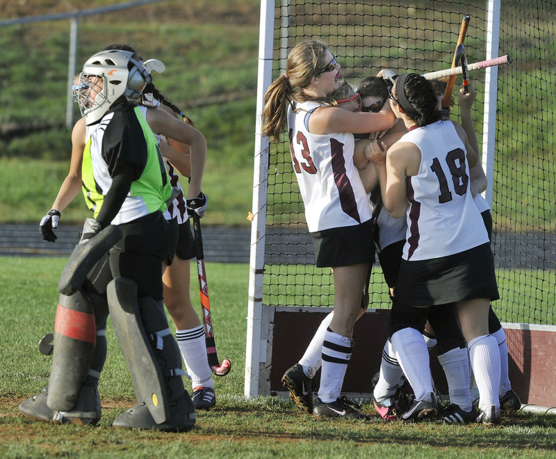 Leavitt goalie Taylor Eells walks away Thursday as Julia Maine is hugged after scoring the goal that gave Greely a 1-0 victory.