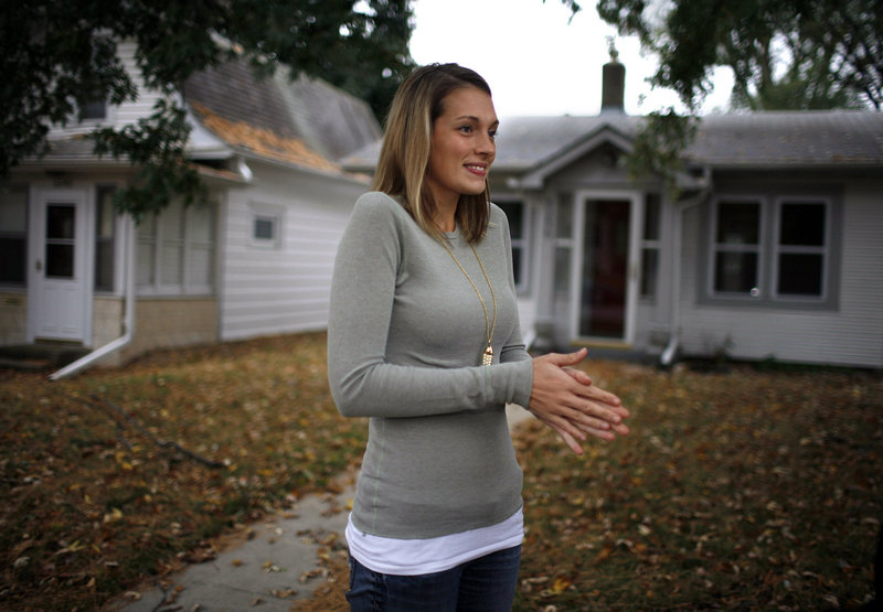 Jessica Harrison stands in front of the home she bought this month in Minneapolis. Harrison, a schoolteacher, looked at countless homes in a two-year search. “A lot of the houses needed a lot of work, and I didn’t have the money or resources to do that,” she says.