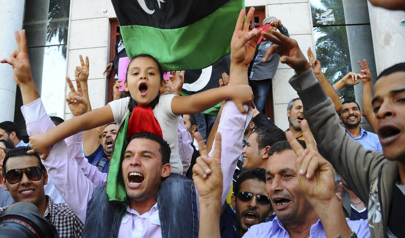 Libyans living in Tunisia celebrate Thursday outside the Libyan Embassy in Tunis upon hearing news of Moammar Gadhafi’s capture and death. In the U.S., President Obama congratulated the Libyan people: “You have won your revolution,” he said. To his fellow Americans he announced, “We achieved our objectives.”