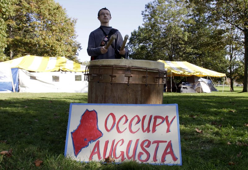 Curtis Cole of Pittston pounds drums in a park across from the State House in Augusta on Monday. A letter writer says such movements will shape the next election.