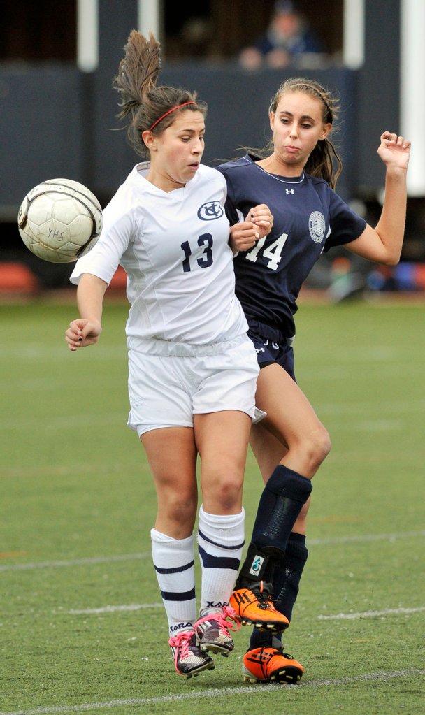 Mo McNaboe, left, of Yarmouth and Fryeburg Academy’s Sydney Charles contend for a loose ball in a girls’ soccer prelim.