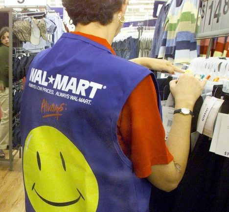 A customer service employee sorts through a clothing rack as patrons shop at the Walmart in North Richland Hills, Texas. . Starting next year, future part-timers will no longer qualify for insurance, and existing full-time employees will pay more of the cost.