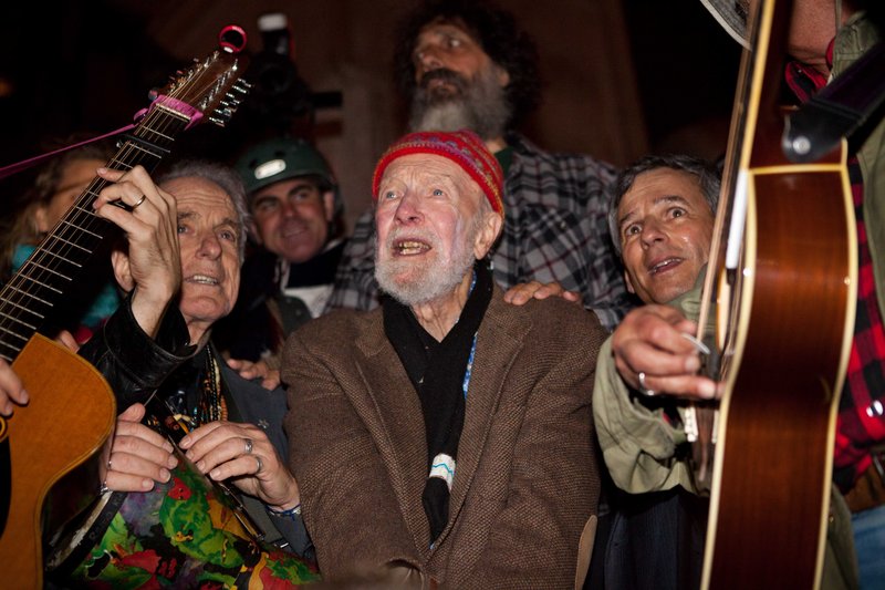 Activist musician Pete Seeger, 92, center, sings before nearly 1,000 people sympathetic to the Occupy Wall Street protests at a brief acoustic concert in New York on Friday.