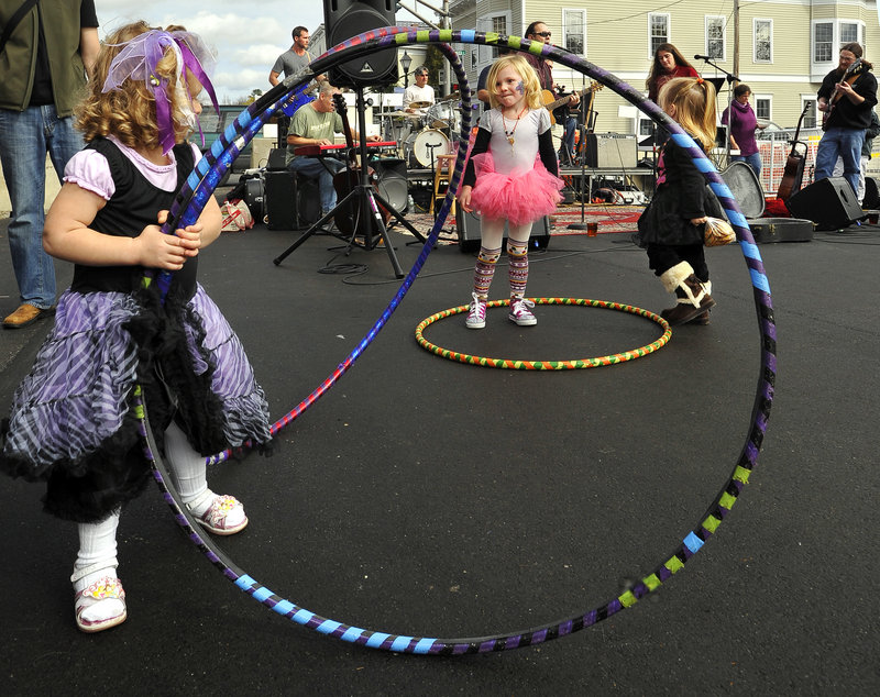 Cadence Bridges, 2, of Kennebunk, from left, Madeline Dowling, 3, and Brianna Auld, 3, both of Kennebunkport, dance with Hip Hoops made by Jen Raymond of Kennebunkport at the Harvest Fest and celebration of the new bridge in Kennebunk on Saturday.