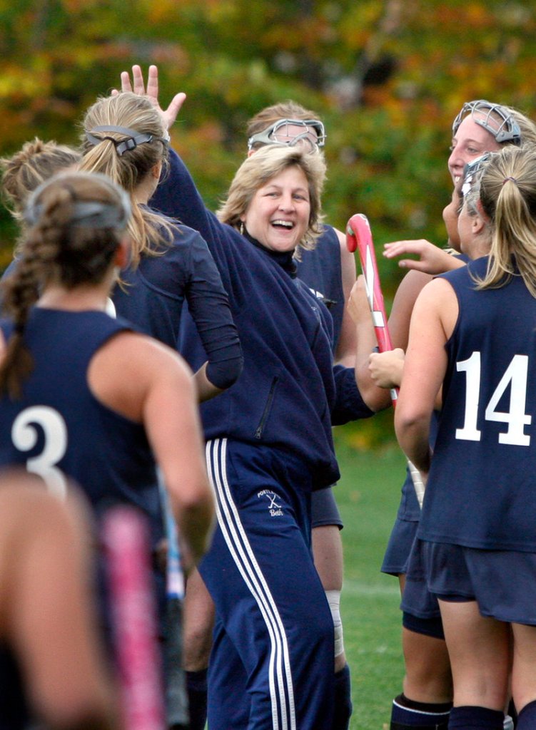 Portland Coach Beth Arsenault celebrates with her team Saturday after the 2-1 victory against Westbrook gave the Bulldogs a spot in the Western Class A field hockey final.