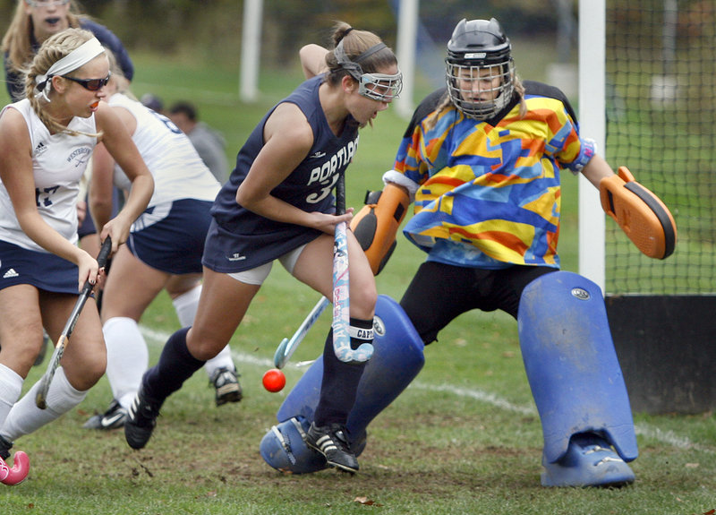 Westbrook goalie Maryssa Arsenault blocks a shot taken by Natalie Anderson of Portland as Katie Conley defends Saturday in the second half of their Western Class A field hockey semifinal. Portland won 2-1 and will meet Marshwood for the regional championship.