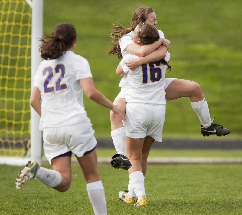 Abby Maker gets a hug from Leeann Morrison (16) after scoring the go-ahead goal late in the second half to give Cheverus a 2-1 playoff victory over Marshwood on Saturday.