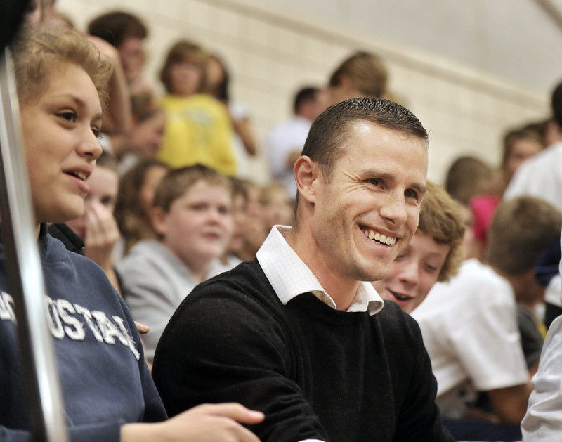 Morgan Cuthbert grins as he is announced as winner of a Milken Educator Award at Monday's surprise assembly.