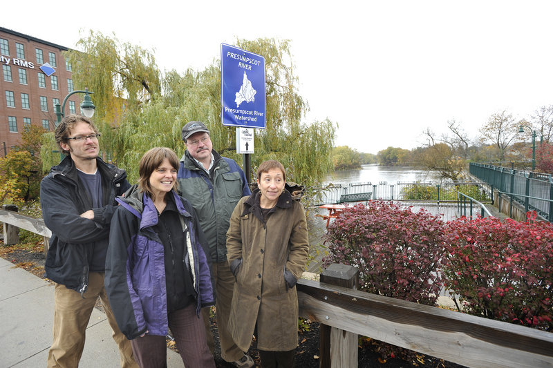 Organizers of the Sebago to the Sea Trail gather by a trail sign in Westbrook this week. They are, from left, Peter Burke of the Westbrook Recreation and Conservation Commission; Tania Neuschafer, project coordinator for the trail; Will Plumley, chairman of the Presumpscot River Watershed Coalition; and Nan Cumming, executive director of Portland Trails.