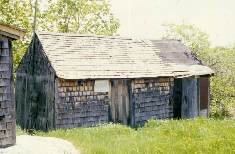 The original privy shed, shown in the early 1980s. The two-seat privy was located along the left side of the shed, which was built in the mid-1800s. Tools and other necessities were stored in the central part of the shed. The door to the right leads to a milk storage area added in the 1930s.