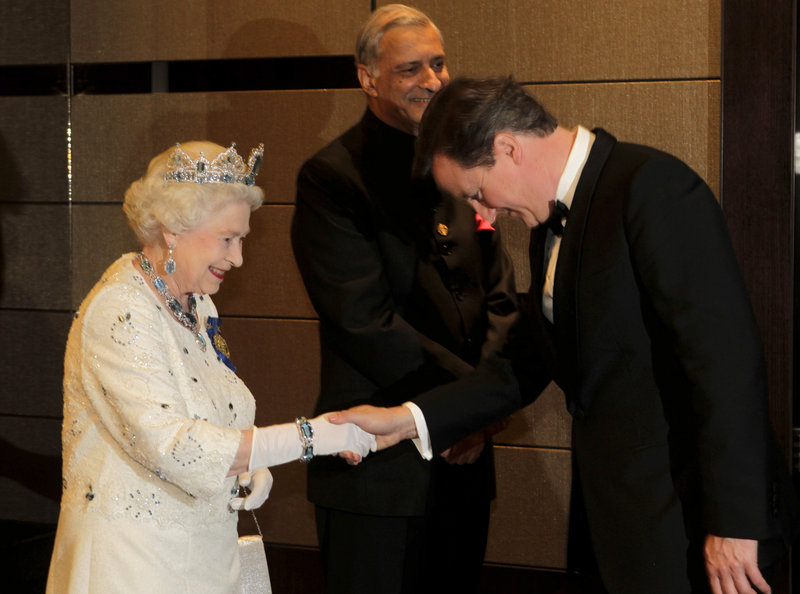 Queen Elizabeth II receives British Prime Minister David Cameron at the Commonwealth Heads of Government banquet held in Perth, Australia, on Friday. Cameron was among those advocating for change in the ancient rules favoring males in the line of succession to the throne.