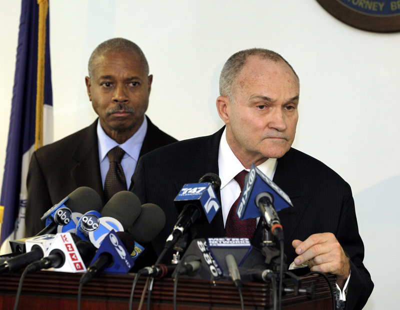 Bronx District Attorney Robert T. Johnson, left, looks on with Police Commissioner Ray Kelly at a news conference Friday about 17 police officers indicted for ticket-fixing.