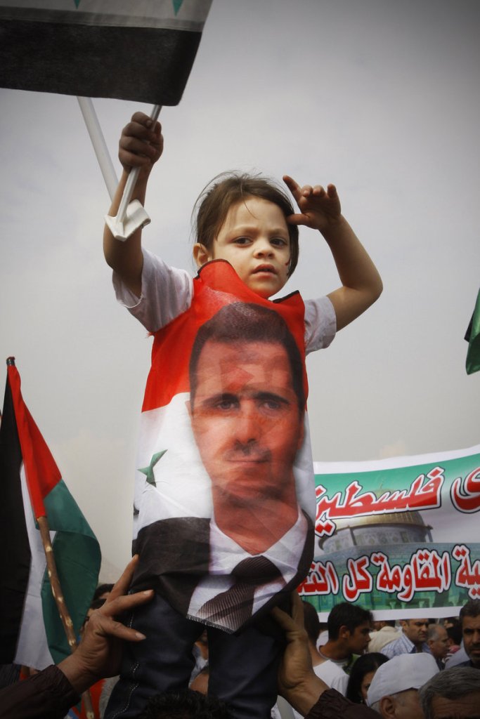 A child looks on during a rally in support of Syrian President Bashar Assad in downtown Damascus on Wednesday. Security forces opened fire on protesters Friday, killing about 30.