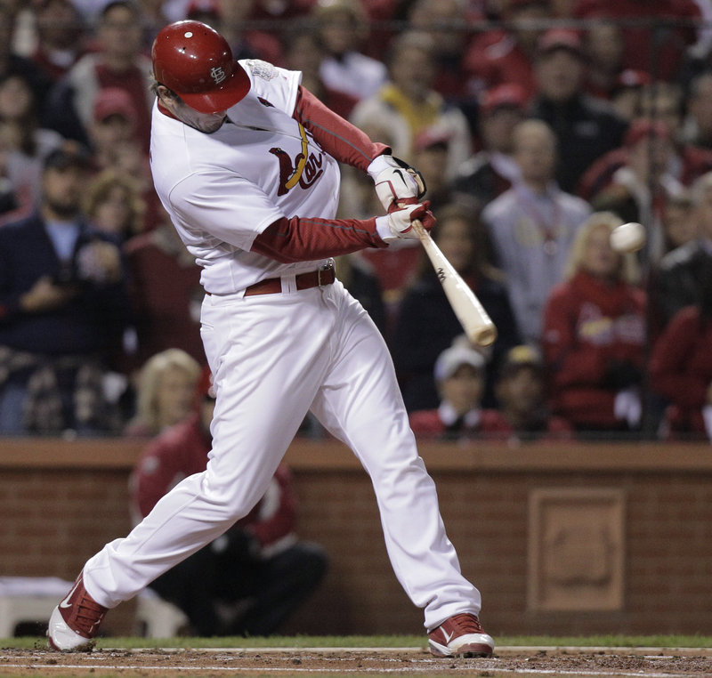 David Freese of the Cardinals drives through a two-run double in the first inning of Game 7. Freese earned the MVP award after hitting a record 21 RBI in the playoffs.