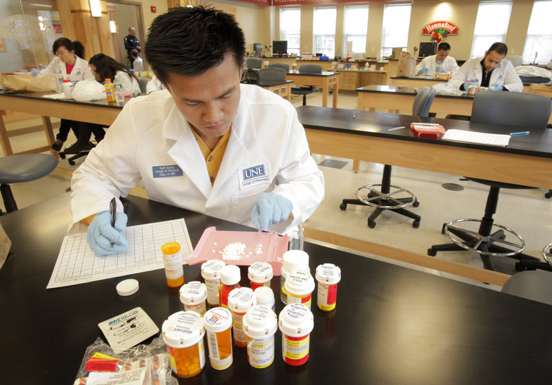 Sanh Duong, a first-year pharmacy student at the University of New England, counts medication that was turned in to the school, which was participating in a national drug take back day on Saturday.