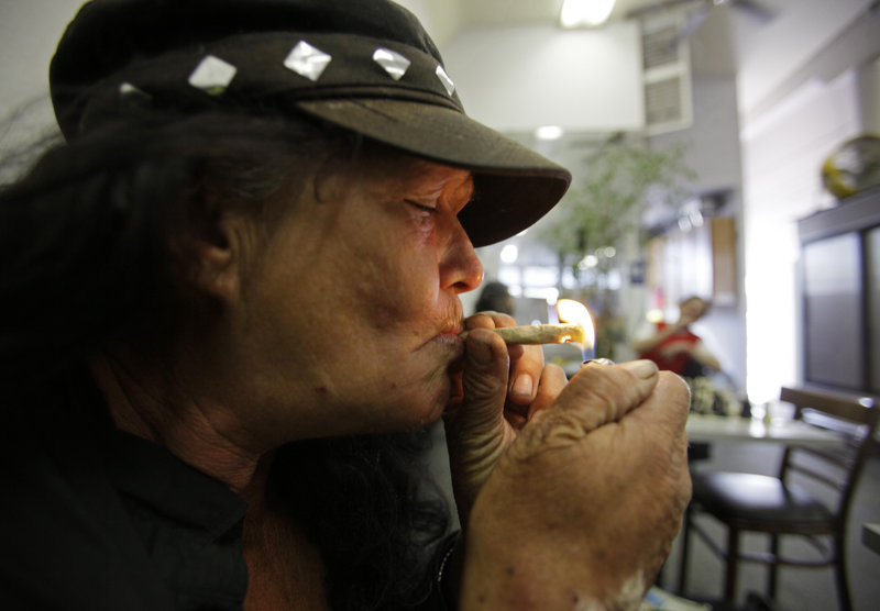 Susan Recht smokes a joint at the San Francisco Medical Cannabis Clinic. The California Medical Association has endorsed decriminalizing recreational pot use for adults.