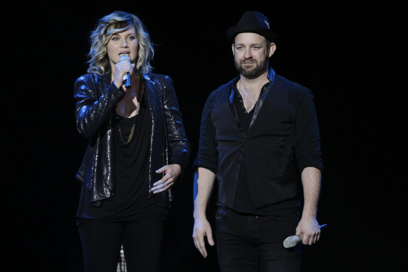 Sugarland’s Jennifer Nettles, left, and Kristian Bush talk to the crowd in Indianapolis before a tribute to victims of a stage collapse at the Indiana State fair last August.