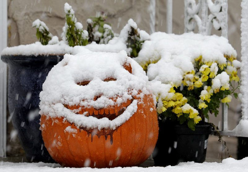 A jack-o'-lantern in North Bergen, N.J., is covered with snow during a rare October snowstorm that hit the Northeast on Saturday. The classic nor'easter was expected to dump a decidedly unseasonal wintry mix on Maine overnight.