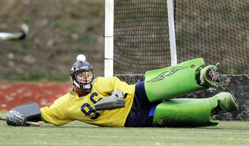 Belfast goalie Julia Ward keeps her eye on the ball while stretching to make a save Saturday during the 2-1 victory against York in the Class B field hockey championship game at Yarmouth. The Lions had to rally after York scored the first goal of the game.