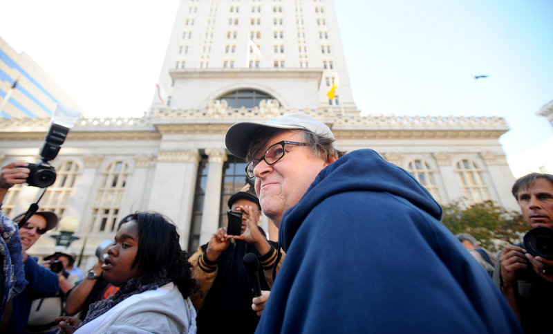 Filmmaker Michael Moore visits with the Occupy Oakland protesters outside City Hall in Oakland, Calif., on Friday. A severe injury to Iraq war veteran Scott Olsen – caused by police, protesters say – has attracted growing attention to this city's participants in the movement.