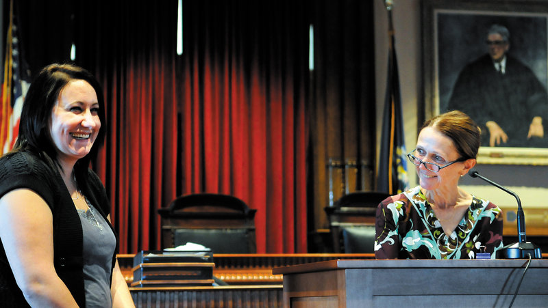 Nichole Rogers, left, laughs as Kennebec County Superior Court Justice Nancy Mills recognizes her last week during a graduation ceremony in Augusta for the Co-Occurring Disorders Court. After being charged with several crimes, Rogers, of Augusta, was enrolled in the program for two years to seek assistance for mental health and substance abuse problems.