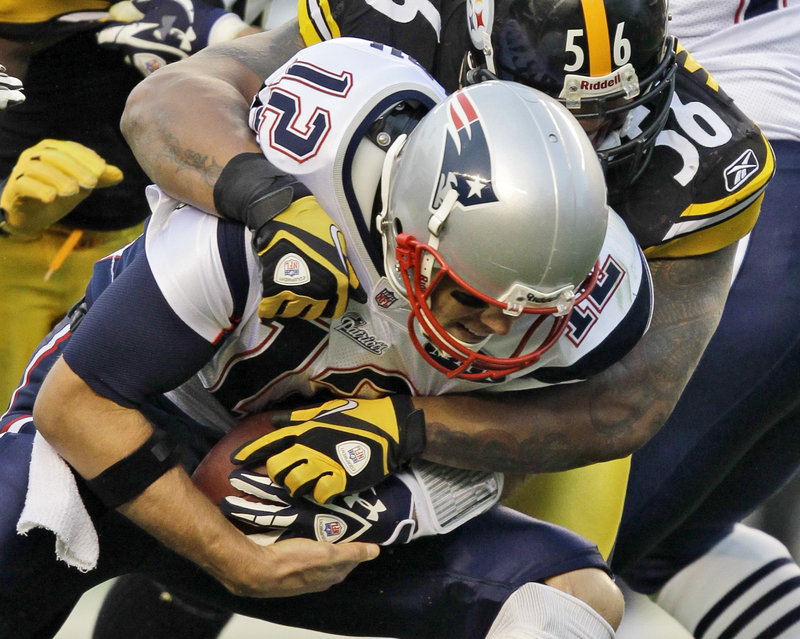 Steelers linebacker LaMarr Woodley sacks Patriots quarterback Tom Brady during Sunday’s game at Heinz Field. Woodley recorded two sacks, and Pittsburgh held the Patriots to season-low totals for yards (213) and points on the way to a 25-17 victory.