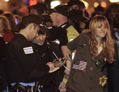 A protester is arrested early Sunday during an Occupy Chicago march and demonstration in the city’s Grant Park.