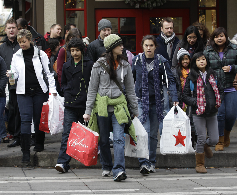Shoppers carry their bags as they walk in downtown Seattle last fall. Spending by American shoppers has slowed to a crawl, prompting lawmakers, businesses and even White House officials to court consumers from cash-rich countries such as China, India and Brazil to pick up the slack.