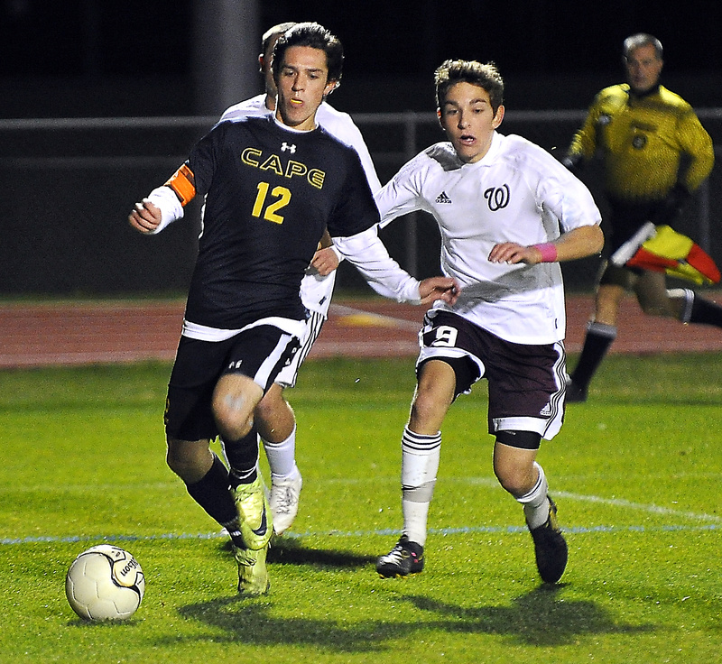 Tim Lavallee of Cape Elizabeth drives toward the goal as Windham’s Dalton Mauro gives chase.