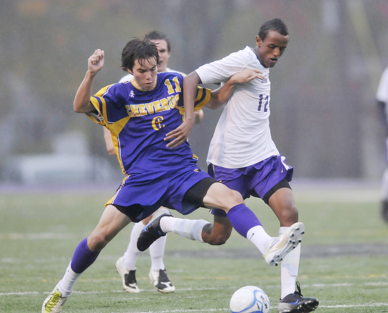Elliot Maker of Cheverus, left, competes with Abdi Hassan of Deering for the ball Thursday night during their Southern Maine Activities Association schoolboy soccer game. Maker scored twice as the Stags earned a 3-0 victory at Deering High.