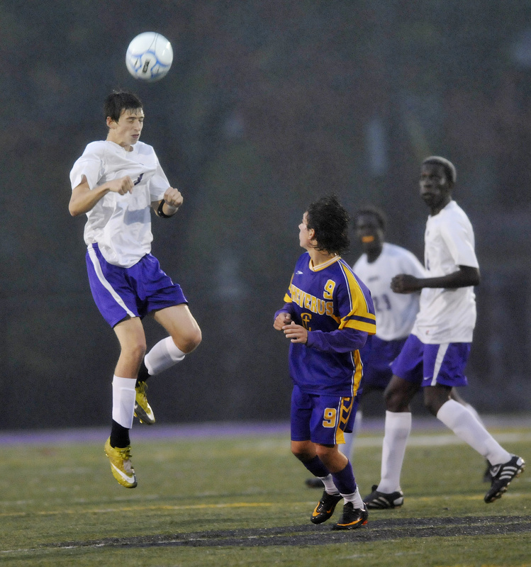 Brandon Saucier of Deering controls the ball with a header in front of Alexander Hoglund of Cheverus during Cheverus’ 3-0 victory Thursday night.