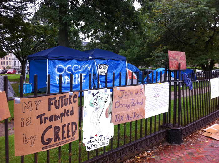 "Occupy" placards carry anti-greed message at Lincoln Park.