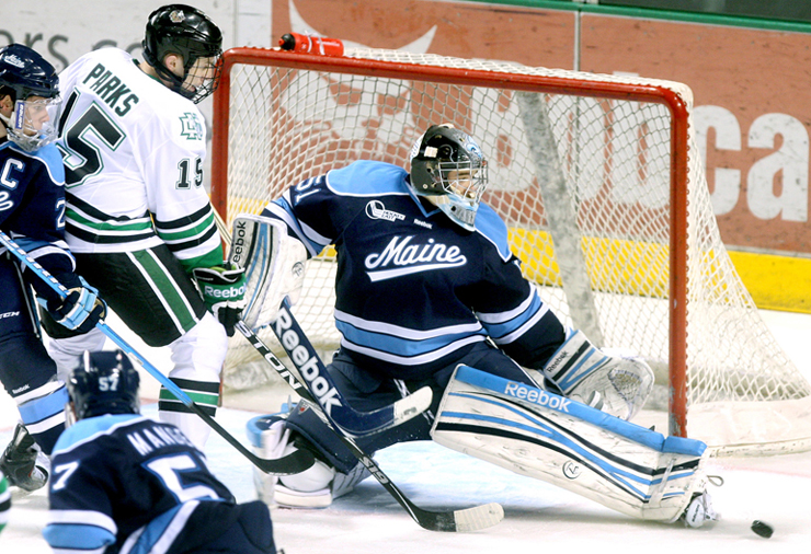 University of Maine goalie Martin Ouellette kicks aside a shot by North Dakota’s Michael Parks for one of his 18 saves Friday night in North Dakota’s 3-1 victory at Grand Forks, N.D.