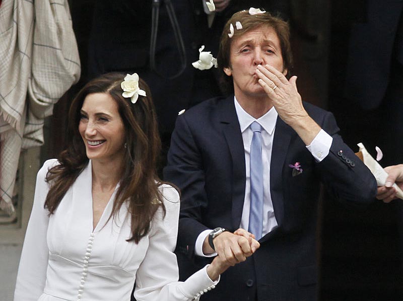 Former Beatle Paul McCartney and his bride, New Yorker Nancy Shevell, exit Old Marylebone Town Hall in London after their wedding Sunday.