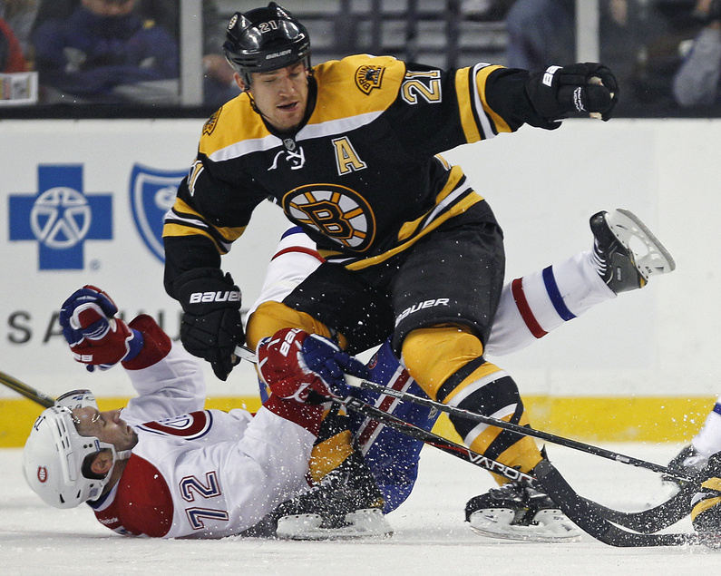 Montreal’s Erik Cole hits the ice hard following a check from Boston’s Andrew Ference during the Canadiens’ 2-1 win Thursday in Boston. The Bruins’ Brad Marchand squared off with P.K. Subban three times during the game.