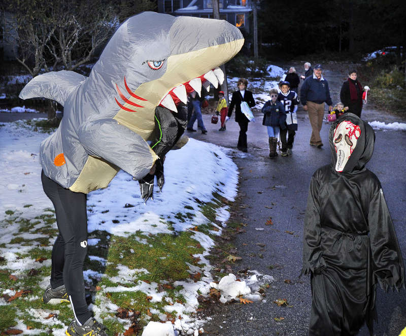 Dressed as the shark from “Jaws,” John Taxter scares Thomas Pender, 8, who was just as scary in his “Scream” mask.