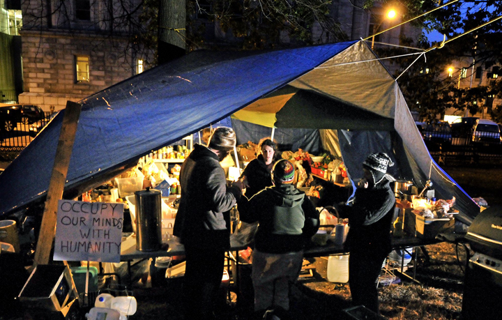 Occupy Maine members gather around the kitchen area of the Lincoln Park encampment.