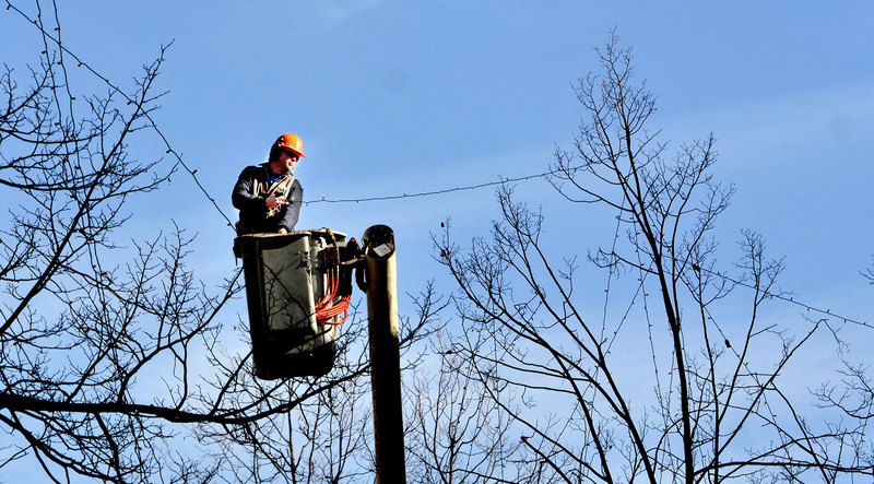 Greg Smith, who works with the forestry division of Portland’s Public Services Department, uses a boom truck Monday to put lights for the coming holiday season in the trees around Monument Square. Smith said it takes him and his co-workers, Jay Ash-Cuthbert and Mike Grant, about two weeks to string all of the lights.