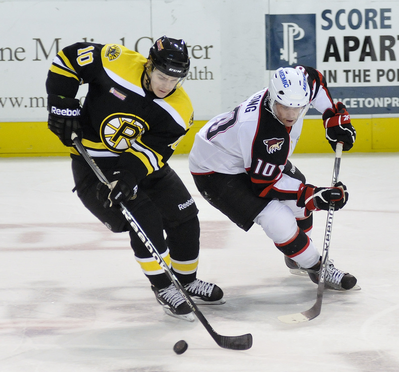 Colin Long of the Portland Pirates goes for the puck against Providence’s Kyle MacKinnon in Saturday night’s game at the Cumberland County Civic Center. The Pirates ended a two-game losing streak with a 4-2 win.
