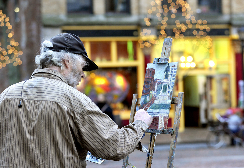 Portland artist Dennis Hare enjoys Monday’s balmy 60-degree weather to paint the scene at Monument Square in Portland. Above-average temperatures are forecast through midweek, with rain expected tonight through Wednesday morning.