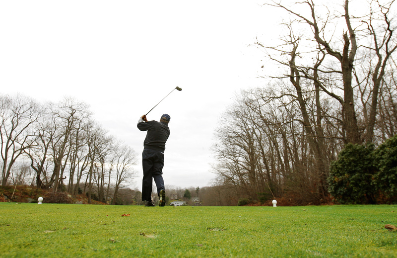 Taking advantage of unseasonably warm temperatures, Dick Carson tees off the first hole at Purpoodock Club in Cape Elizabeth on Tuesday. "If the greens are available, (golfers) are going to be out there playing," said clubhouse manager Robyn Violette.