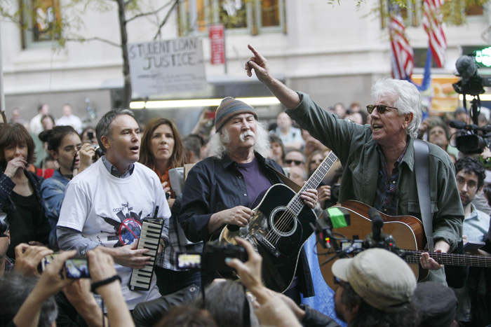David Crosby, center, and Graham Nash, right, perform at the Occupy Wall Street encampment at Zuccotti Park on Nov. 8 in New York.
