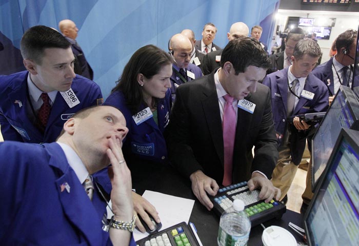 Specialists Jennifer Klesaris, and William Bott, right center, work at a post on the floor of the New York Stock Exchange today.